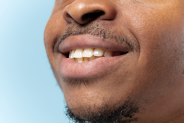 Image showing Close up portrait of young man on blue background.