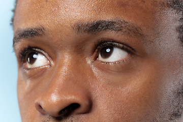 Image showing Close up portrait of young man on blue background.