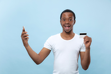 Image showing Half-length close up portrait of young man on blue background.