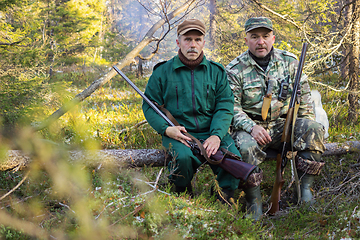 Image showing Two older hunters rest