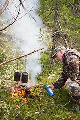 Image showing Hunter in forest fire ignites