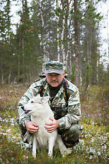 Image showing Huntsman and his dog in the hunting grounds