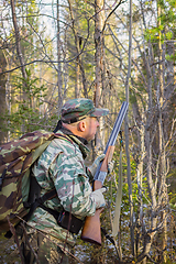 Image showing Hunter stalks the bird in the forest