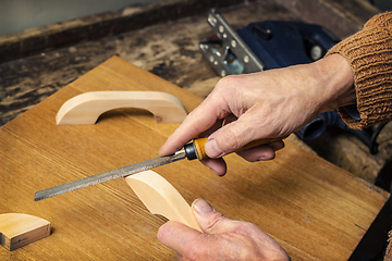 Image showing Carpenter working in a workshop rasp