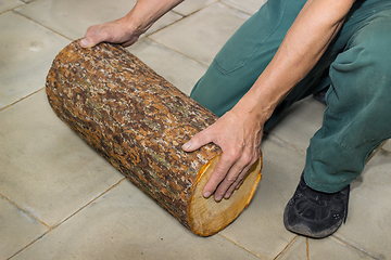 Image showing Billet of logs in the hands of a carpenter