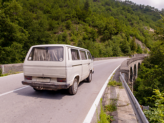 Image showing old white van on asphalt road in beautiful countryside