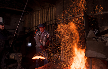 Image showing blacksmith workers using mechanical hammer at workshop