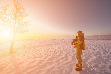 Image showing portrait of male photographer on sunset at winter nature