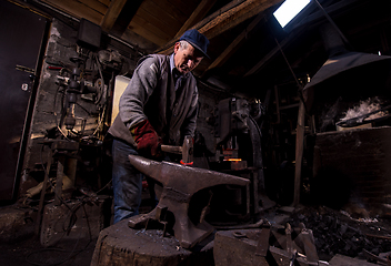 Image showing blacksmith manually forging the molten metal