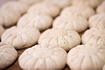 Image showing balls of dough bread getting ready to be baked