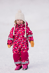 Image showing little girl having fun at snowy winter day