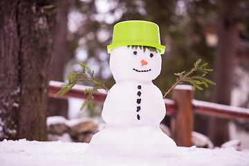 Image showing smiling snowman with green hat