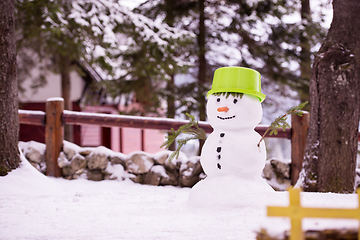 Image showing smiling snowman with green hat