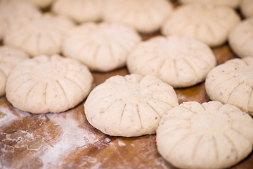 Image showing balls of dough bread getting ready to be baked