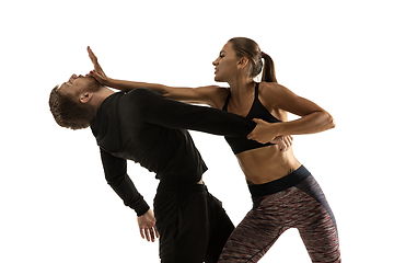 Image showing Man and woman fighting in studio, women\'s self-defense concept