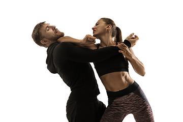 Image showing Man and woman fighting in studio, women\'s self-defense concept