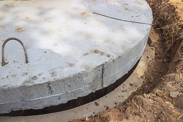 Image showing Massive concrete cap installed on the well