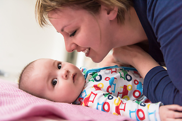 Image showing young mother kissing her cute little baby