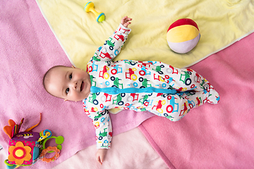 Image showing top view of newborn baby boy lying on colorful blankets