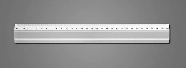 Image showing Metal ruler isolated on dark grey background