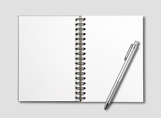 Image showing Blank open spiral notebook and pen isolated on grey