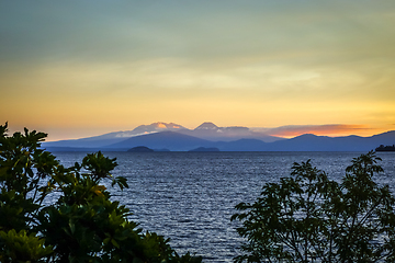 Image showing Taupo Lake and Tongariro volcano at sunset, New Zealand