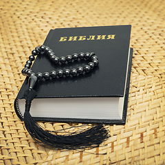 Image showing Rosary on Bible put on a straw chair