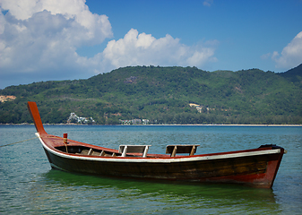 Image showing Thai wooden boat on a calm sea bay