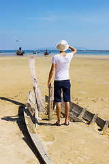 Image showing Young stranger standing on the shattered boat