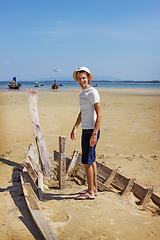 Image showing Happy camper standing on the shattered boat