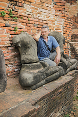 Image showing Tourist thought, sitting on the ruins of an monastery, Thailand 