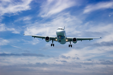 Image showing Airplane landing at sunset