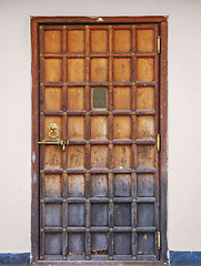 Image showing Old wooden door with a bronze lock