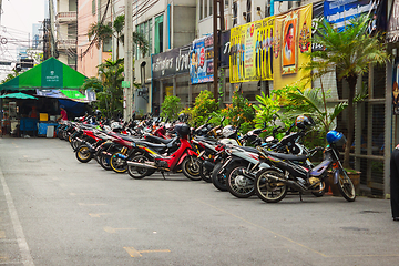 Image showing Scooters parked along the street in town. Bangkok