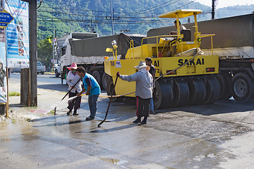 Image showing People are working on repairing the road