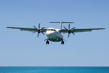 Image showing Turboprop aircraft, Landing in Phuket International Airport in Thailand, flies from the ocean