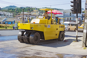 Image showing  Workers operating asphalt paver machine