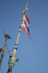 Image showing Storms battered the Thai flag on the mast