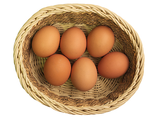 Image showing Eggs in wicker basket on white background, top view