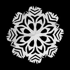 Image showing On black background lie white snowflake, cut from paper