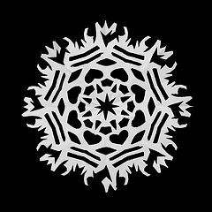 Image showing On a black background lie a paper snowflake