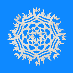 Image showing On a blue background lie a paper snowflake