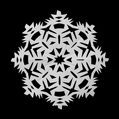 Image showing Snowflake from paper and lies on black background