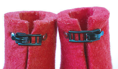 Image showing Iron clasps on the felt red boots white background