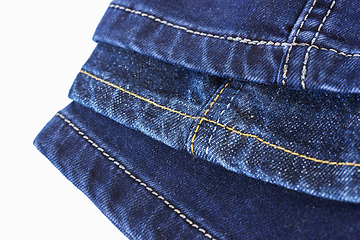 Image showing Various seams blue denim trousers on white background