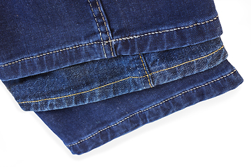 Image showing Thread seam on blue denim trousers on white background