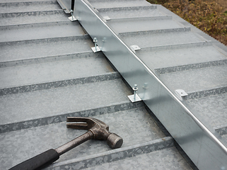 Image showing The barrier for snow guard on the edge of roof