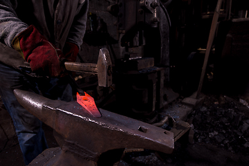 Image showing blacksmith manually forging the molten metal