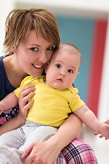 Image showing Portrait of young happy mother holding newborn baby boy