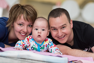 Image showing Portrait of young happy couple with their adorable baby boy